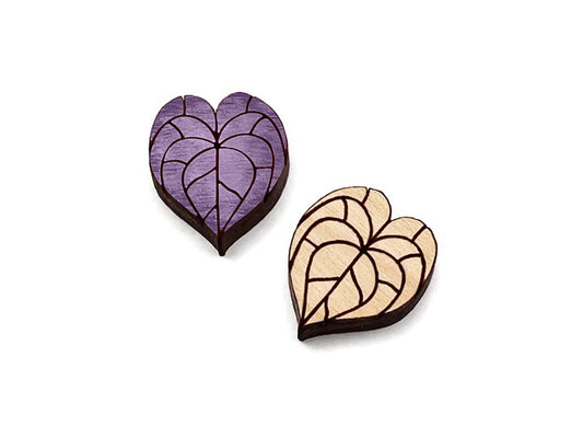 a pair of wooden cabochon stud earring blanks cut and engraved to look like anthurium leaves