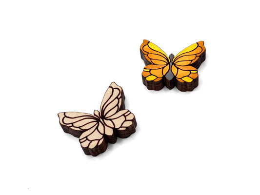 a pair of wooden cabochon stud earring blanks cut and engraved to look like butterflies