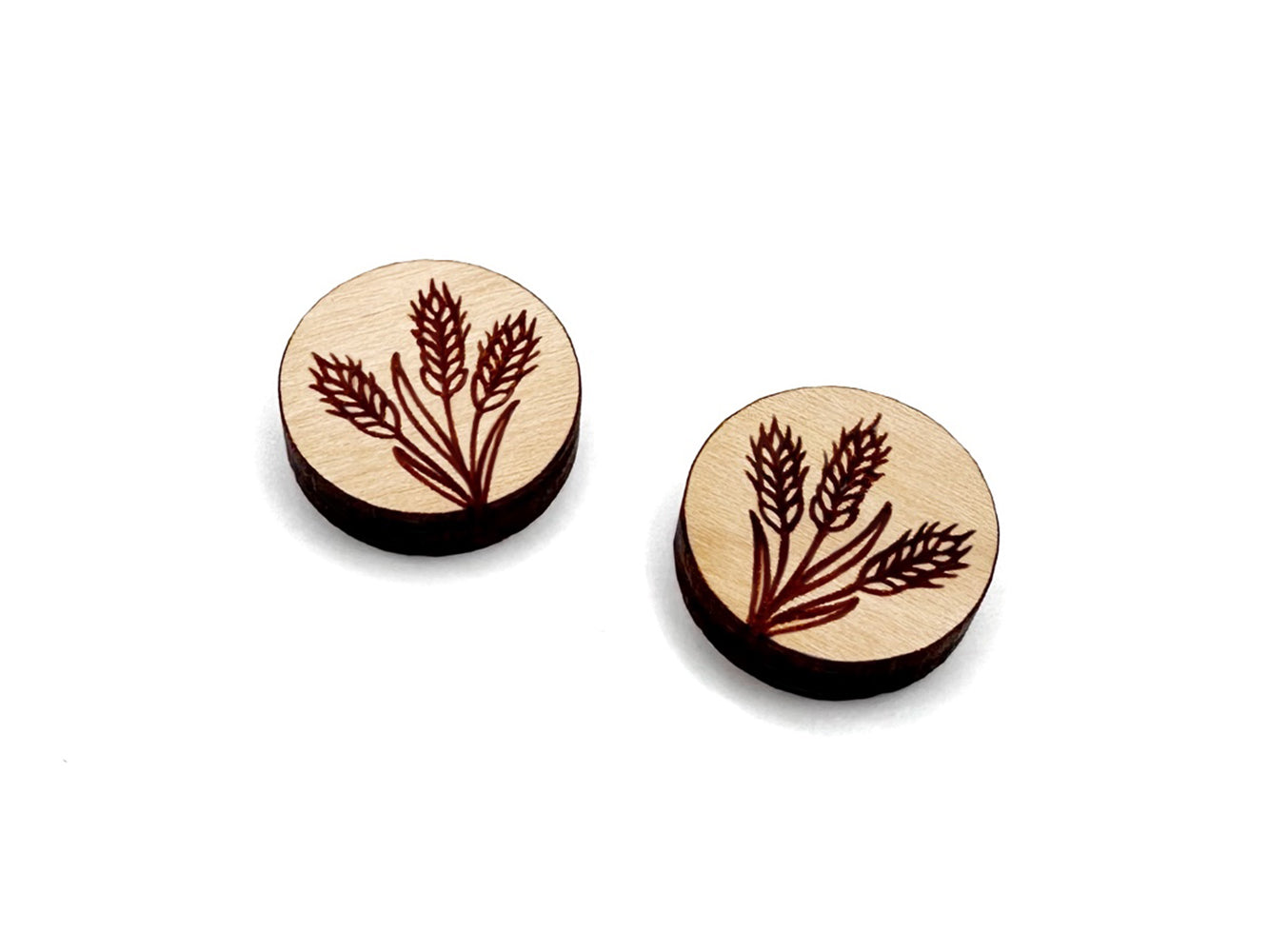 a pair of round wooden cabochon earring blanks engraved with a wheat design