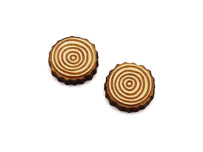 a pair of wooden cabochon stud earring blanks cut and engraved to look like slices of wood