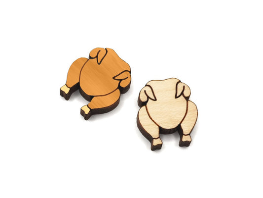 a pair of small wooden cabochon blanks for stud earrings, cut and engraved to look like a roast turkey