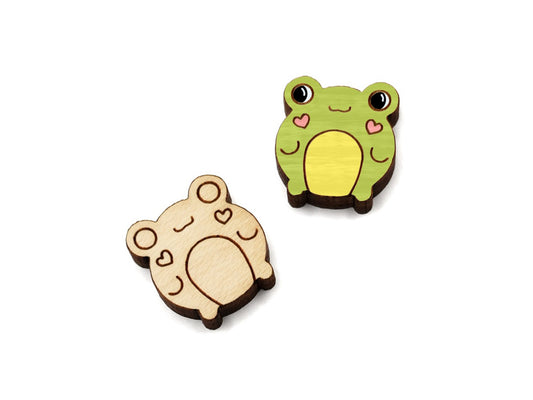 a pair of small wooden cabochon blanks for stud earrings, cut and engraved to look like cute frogs