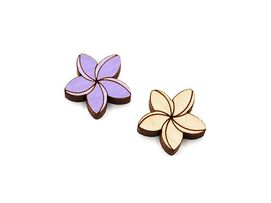 a pair of wooden flat-back cabochon blanks, engraved and cut to look like plumeria flowers