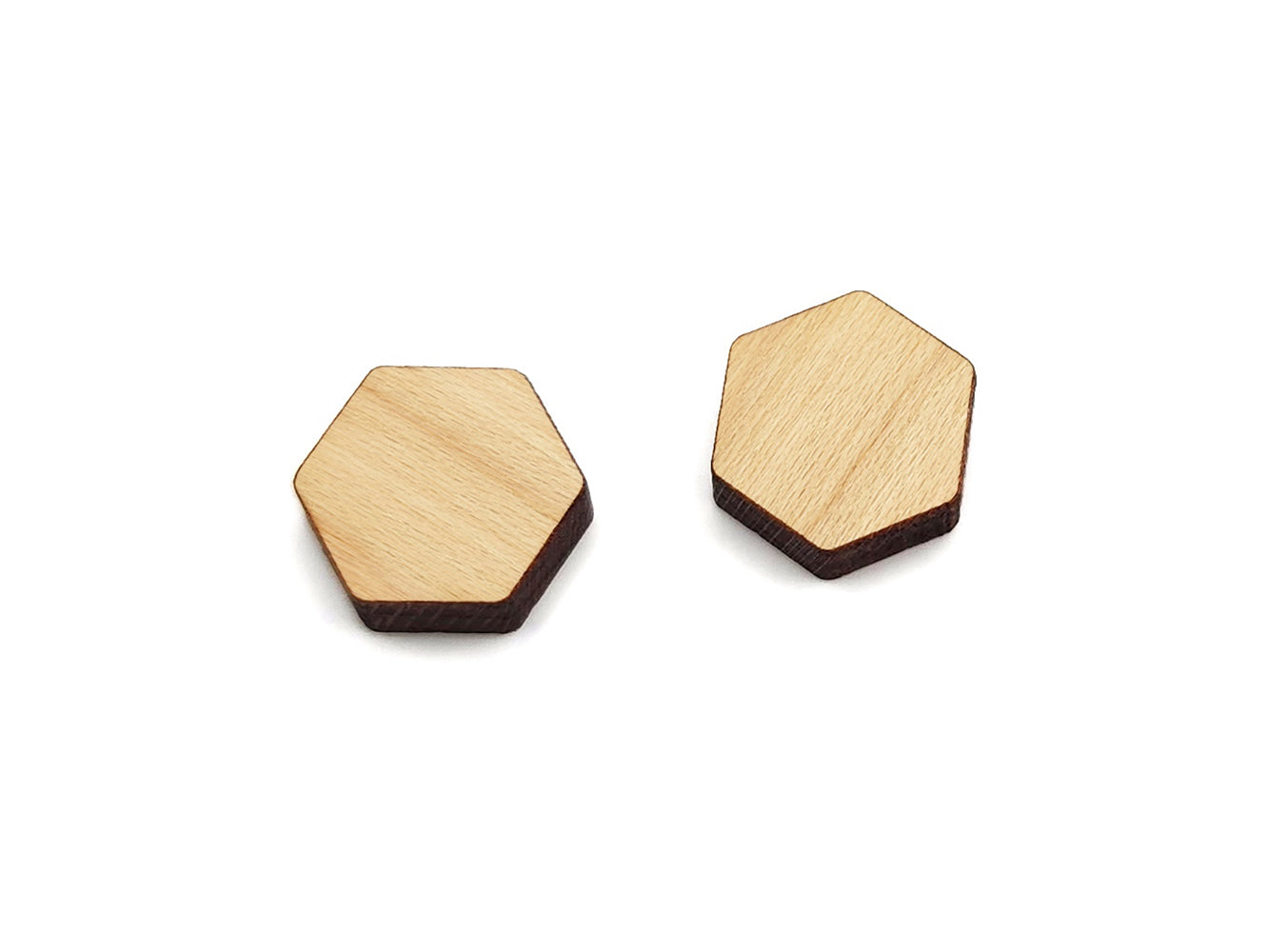 a pair of small acrylic and wood cabochon blanks for stud earrings, cut in the shape of a hexagon