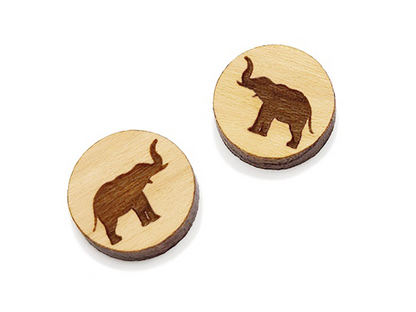 a pair of wooden earrings with an elephant design