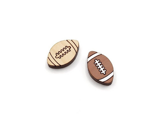 a pair of wooden cabochon stud earring blanks cut and engraved to look like footballs