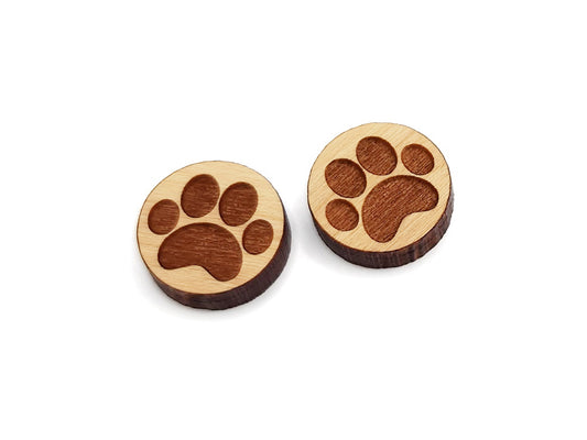 a pair of wooden earrings with a paw print