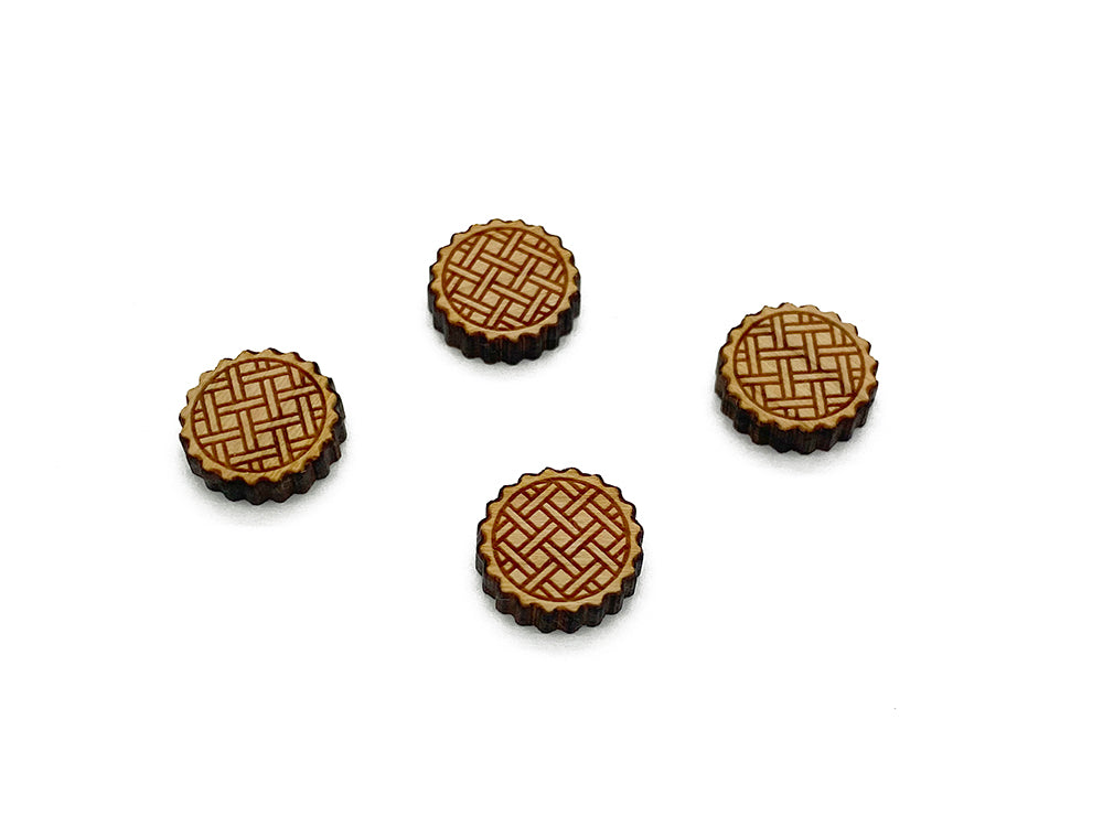 a group of three wooden buttons sitting on top of a white surface