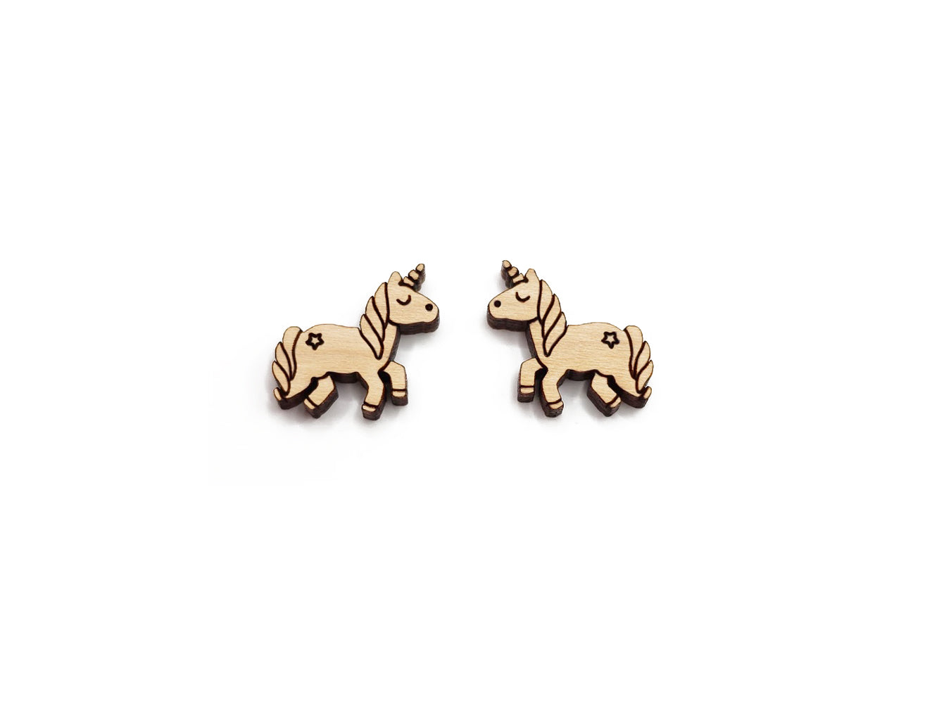 a pair of wooden cabochon stud earring blanks cut and engraved to look like a unicorn