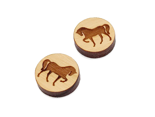 a pair of small round wooden cabochon blanks for stud earrings engraved with the silhouette of a horse