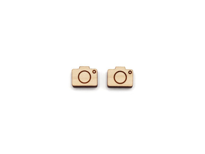 a pair of wooden cabochon stud earring blanks cut and engraved to look like a camera