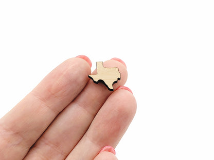 a person holding a small wooden piece in their hand