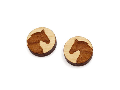 a pair of small round wooden cabochon blanks for stud earrings engraved with the silhouette of a horse