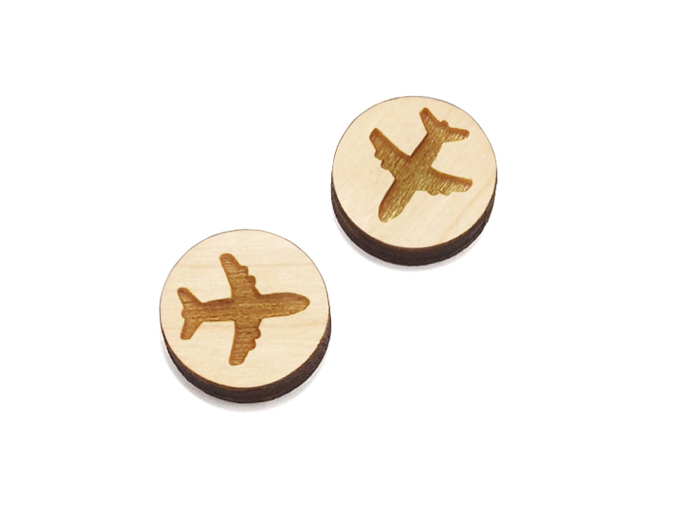 a pair of small round wooden cabochon blanks for stud earrings engraved with the silhouette of an airplane.