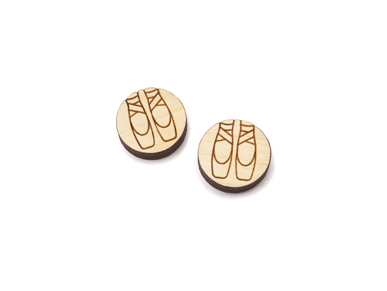 a pair of round wooden cabochon earring blanks engraved with a pair of ballet slippers