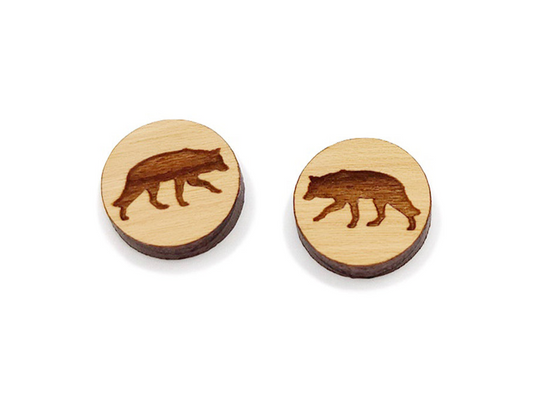 a pair of round wooden cabochon earring blanks engraved with a wolf silhouette design