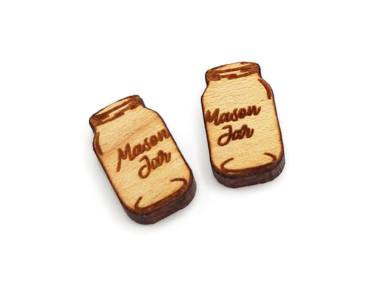 a pair of small wooden cabochon blanks for stud earrings, cut and engraved to look like mason jars