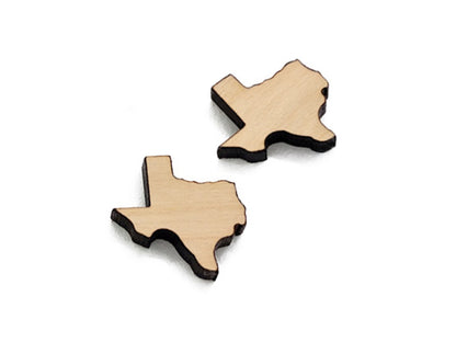 a pair of small acrylic and wood cabochon blanks for stud earrings, cut in the shape of Texas