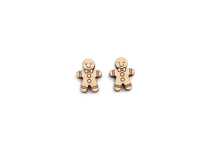 a pair of wooden cabochon stud earring blanks cut and engraved to look like a gingerbread man