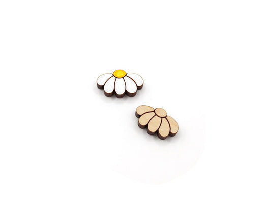 a pair of wooden cabochon stud earring blanks cut and engraved to look like daisy flowers