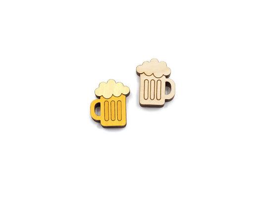 a pair of wooden cabochon stud earring blanks cut and engraved to look like mugs of beer