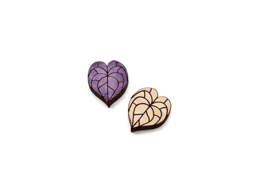 a pair of wooden cabochon stud earring blanks cut and engraved to look like anthurium leaves