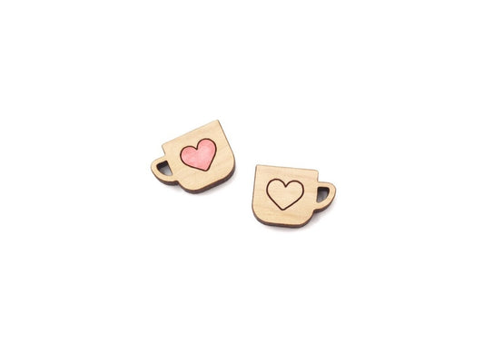 a pair of wooden cabochon stud earring blanks cut and engraved to look like mugs with a heart outline