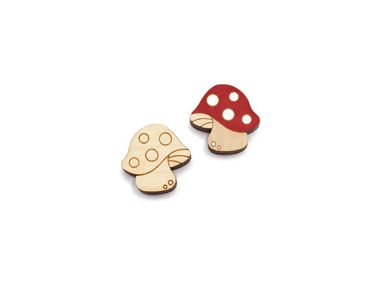 a pair of wooden cabochon stud earring blanks cut and engraved to look like spotted mushrooms
