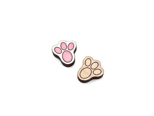 a pair of wooden cabochon stud earring blanks cut and engraved to look like bunny feet