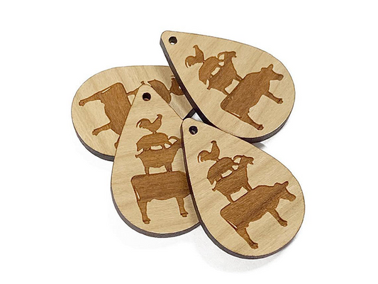 four wooden guitar picks with different designs on them