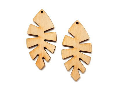 a pair of wooden earrings on a white background