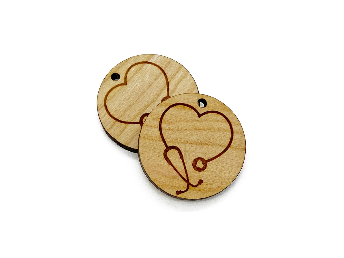 two wooden coasters with a heart and a stethoscope on them