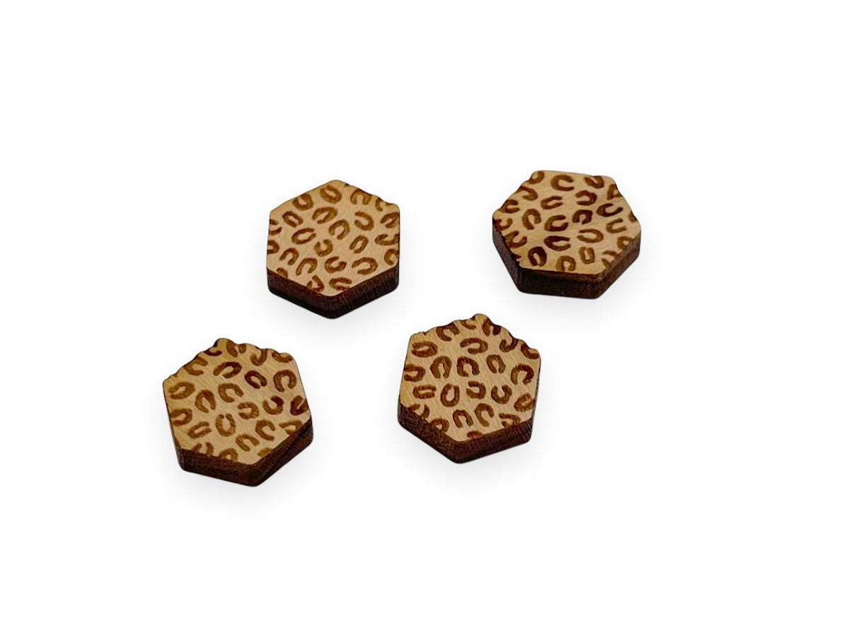 a pair of hexagon shaped wooden cabochon stud earring blanks engraved with cheetah print