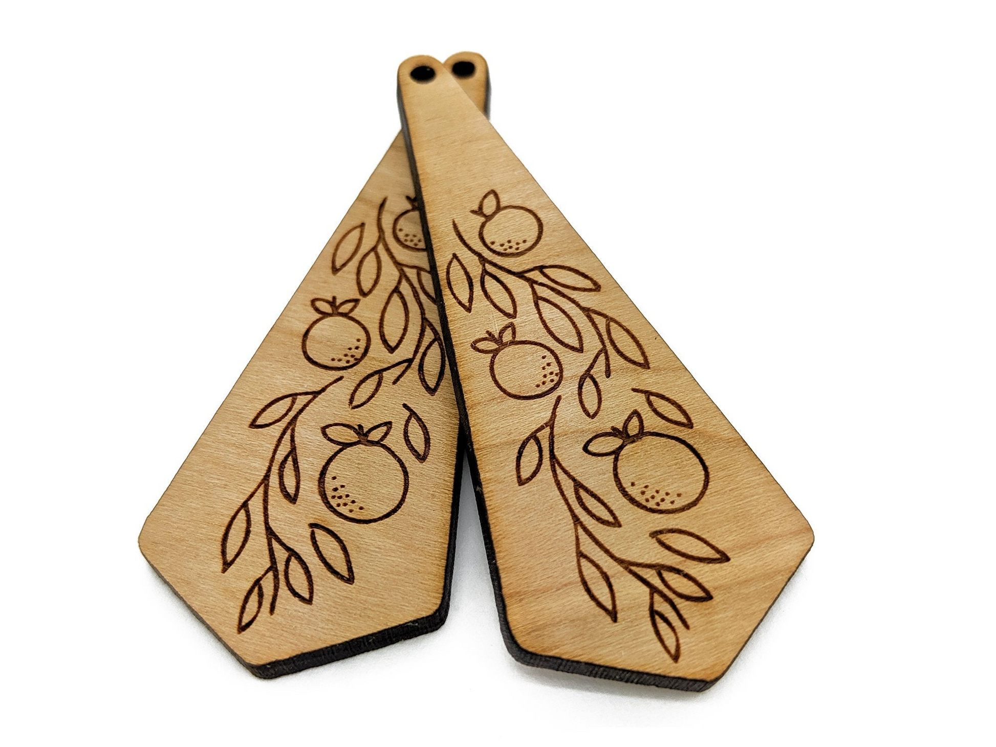two wooden paddles with designs on them