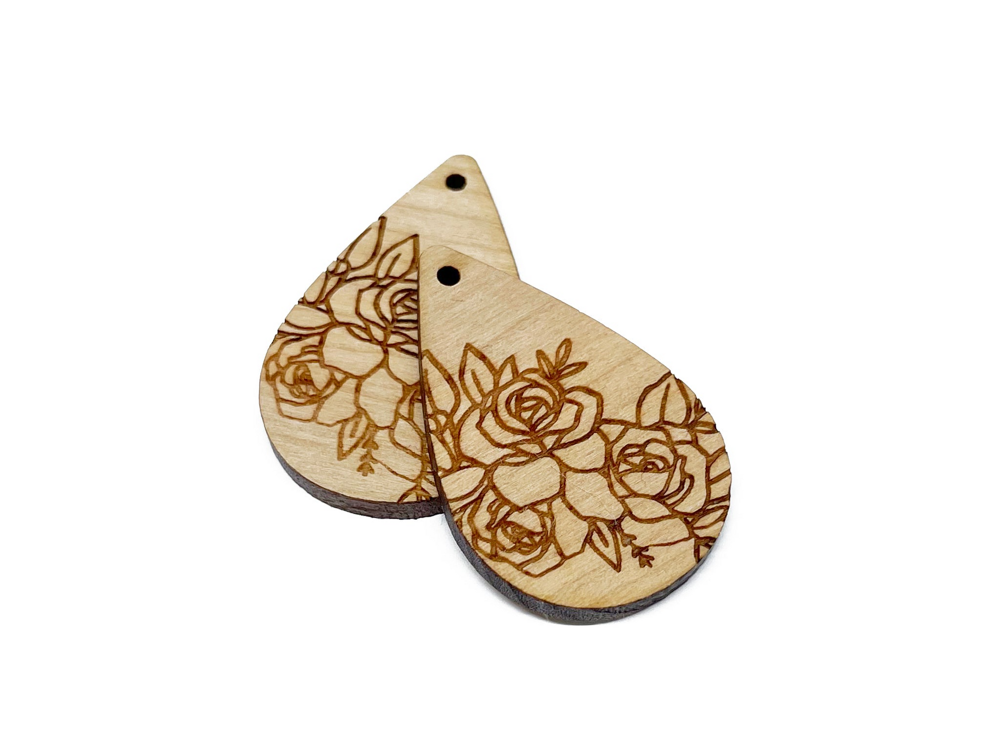 a pair of wooden earrings with flowers on them