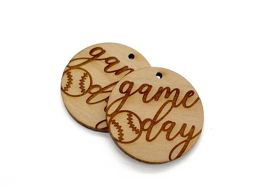 two wooden buttons with the words game day written on them