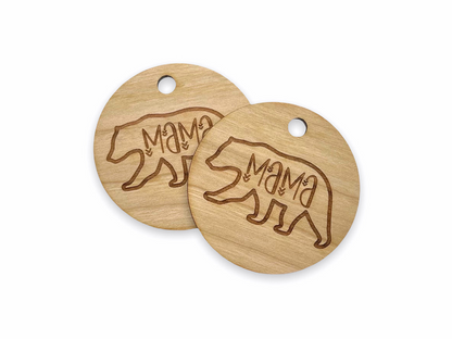 two wooden tags with a bear design on them