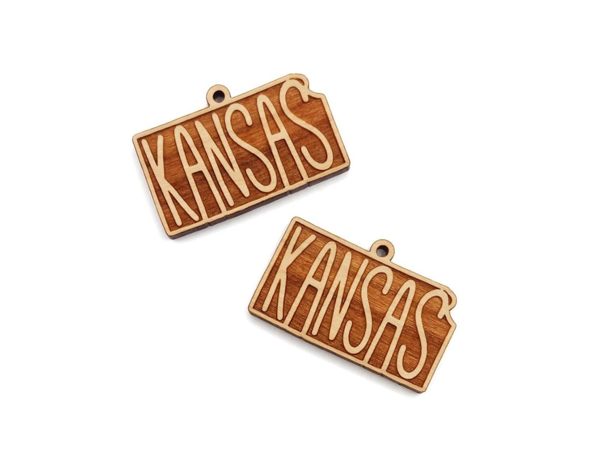 two wooden name tags with the word kansas on them
