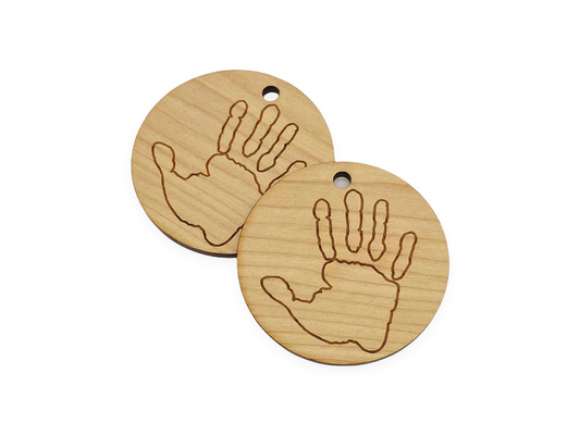 two wooden tags with hand prints on them