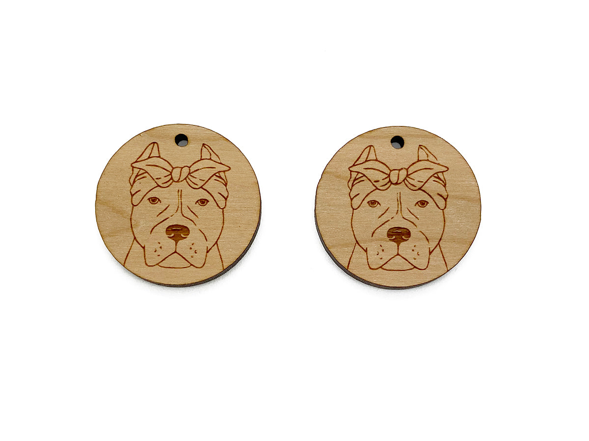 two wooden tags with a dog's face on them