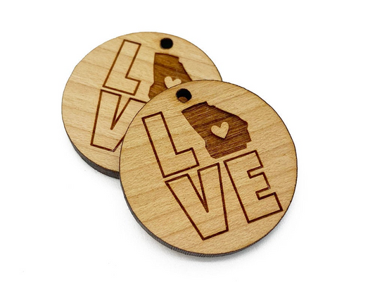 two wooden tags with the words love and a bear