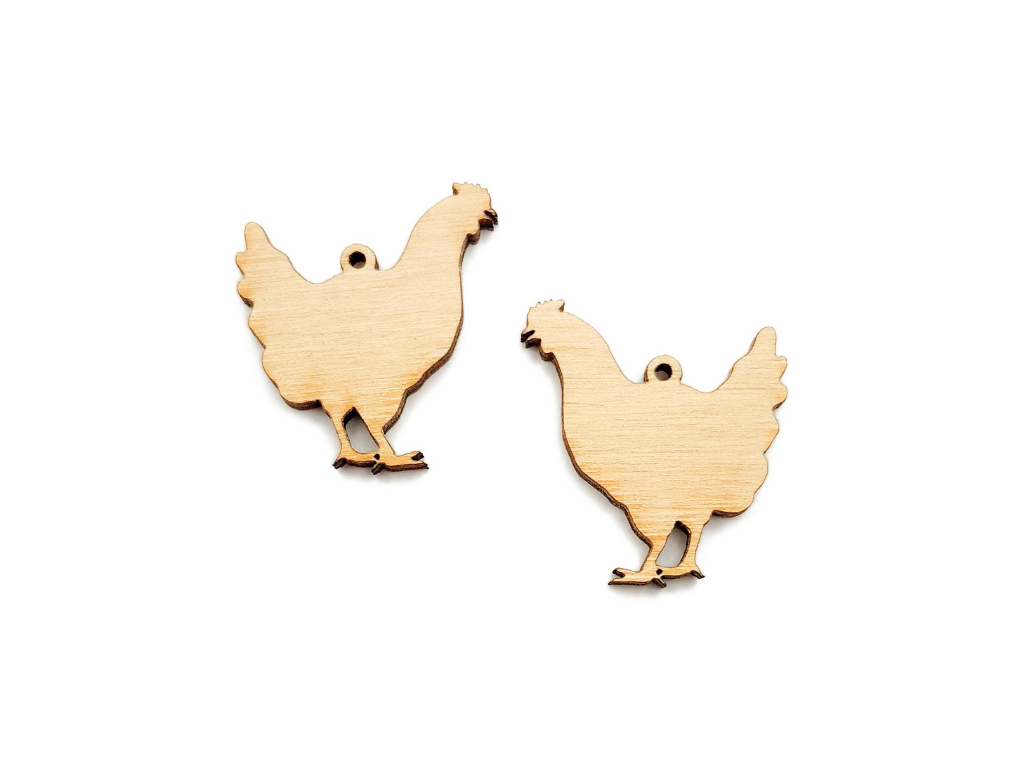 a pair of wooden chickens on a white background