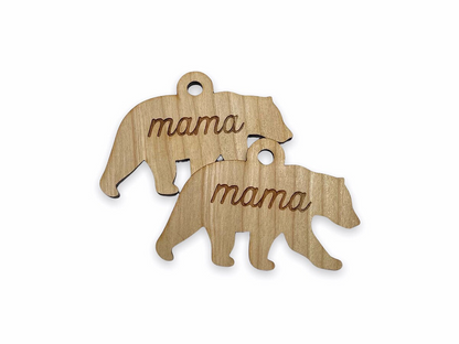 a couple of wooden ornaments that say mama and baby