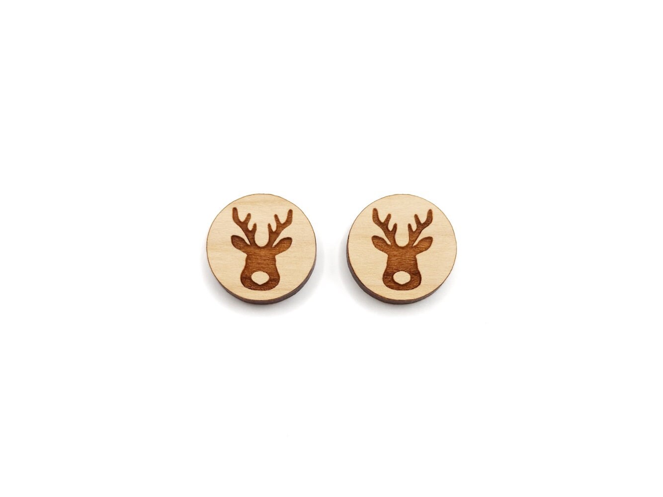 a pair of round wooden cabochon earring blanks engraved with a Christmas Reindeer